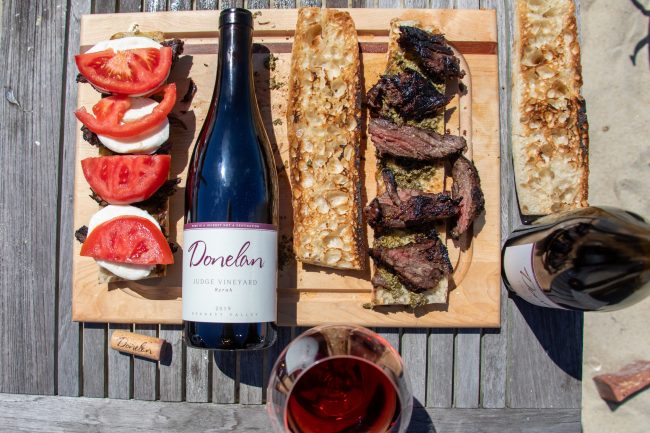 Board with food and wine on it