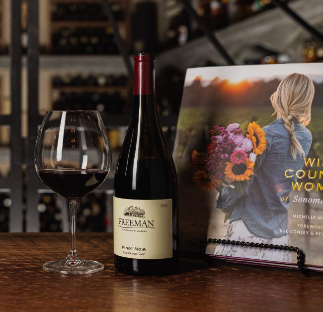 Bottle of Freeman Pinot Noir next to a book