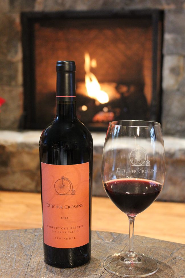 Bottle of Dutcher Crossing Zinfandel in front of a fire